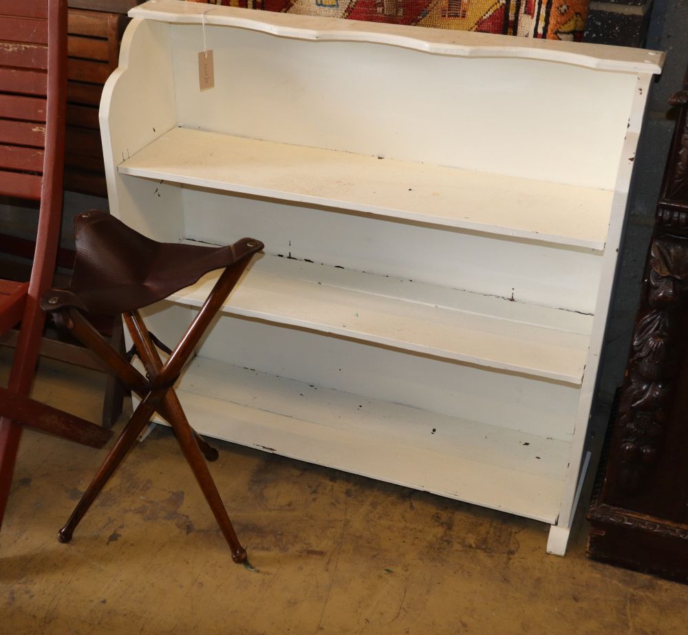 A painted bookcase and folding seat, bookcase W.96cm, D.25cm, H.86cm